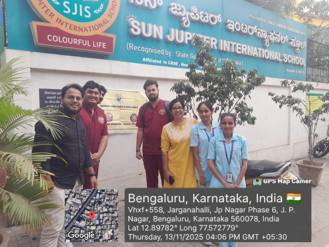 Dental team members posing outside Sun Jupiter International School